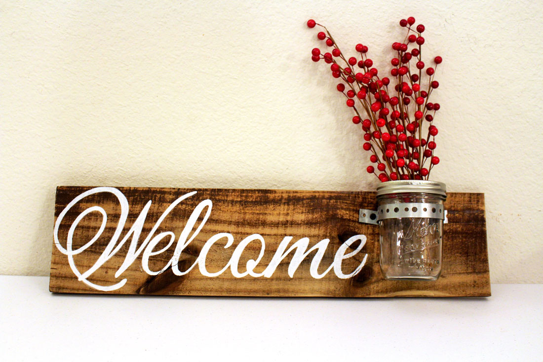 welcome w mason jar with red branches